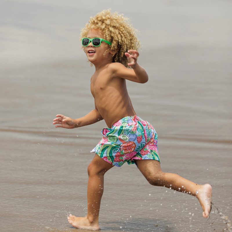 Keanu Tetteh running along the beach in swim shorts